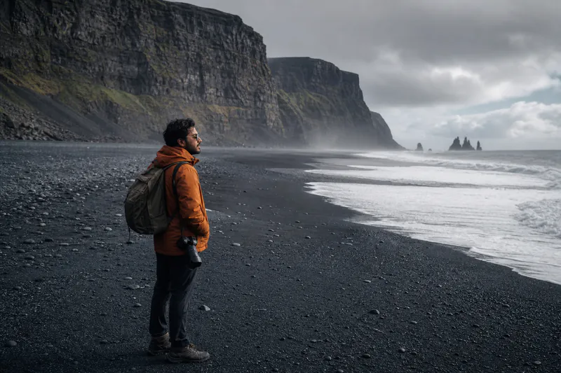 A young Indian traveller taking in Iceland's black-sand coast